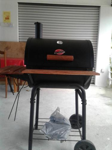 a grill sitting on a table in a room at Maena Water Chalets in Tumpat