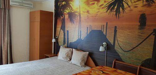 a bedroom with a bed with a painting on the wall at Apartament Belvedere in Olimp