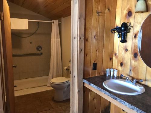 a bathroom with a sink and a toilet and a shower at Heart Six Ranch in Moran