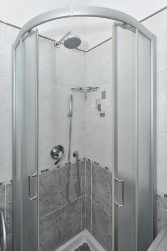 a shower with a glass door in a bathroom at CASA FLAVIA in Maiori