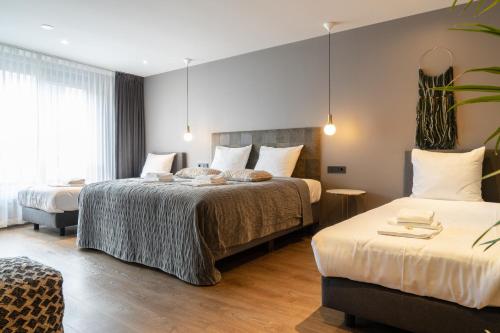 a hotel room with two beds in a room at Boutique Suites Lisse - Keukenhof in Lisse