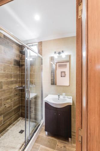a bathroom with a sink and a shower at Quinta Vita - Vila Limao in Almancil
