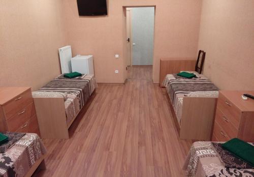 a room with three beds and a mirror at Art Hotel in Izmail
