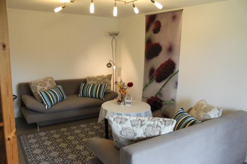 a living room with a couch and a table at Ferienwohnung Schmahl in Schleiden