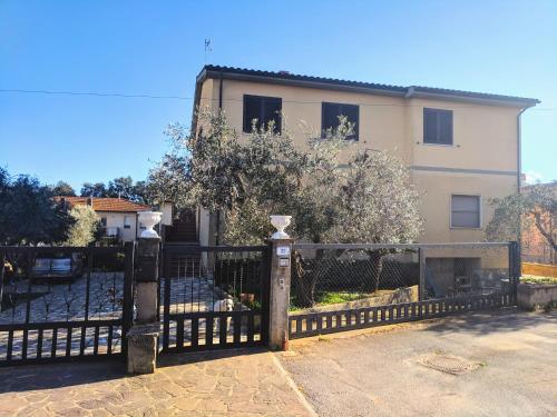 a black fence in front of a house at Maremmano BnB in Capalbio