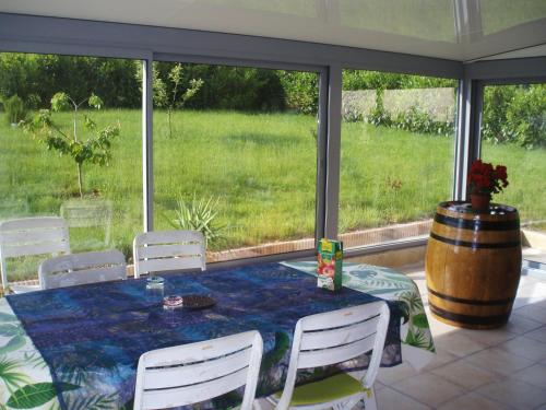 a dining room with a table and chairs and a barrel at Chambre d'Hôte de la Belle Jardinière in Chagny