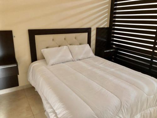 En eller flere senge i et værelse på Departamento Centrico C/ Asador Propio