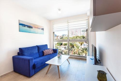 a living room with a blue couch and a table at Melior-1 in Calpe