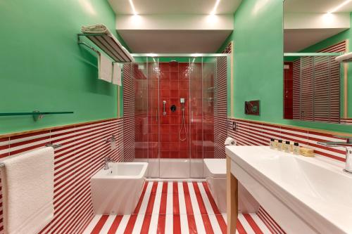 a bathroom with a red and white striped floor at Casa Dominova de Luxe in Sorrento