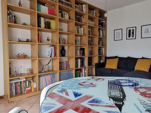 a living room with a bed and book shelves at Horus apartment in Padova