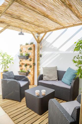 a patio with two chairs and a table at Tales Of Us Terrace in Aveiro