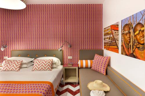 a bedroom with two beds and a red wall at Casa Dominova de Luxe in Sorrento