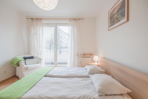 a bedroom with a large bed and a window at CITYSTAY Okrzei Sopot Apartment in Sopot