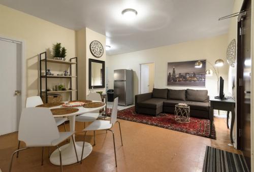 a living room with a table and a couch at 1549 North Maplewood Avenue in Chicago