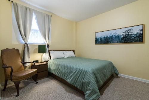 a bedroom with a bed and a chair and a window at 1549 North Maplewood Avenue in Chicago