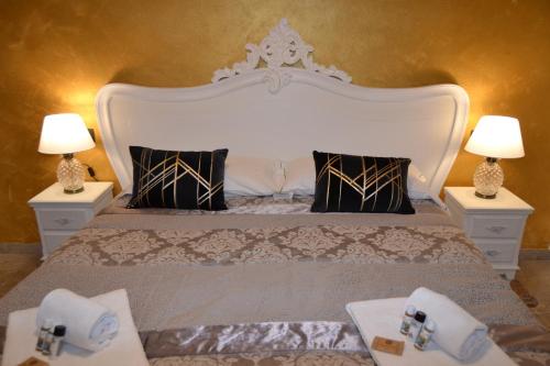 a bedroom with a large bed with two lamps at Rio Groppo Guesthouse in Manarola