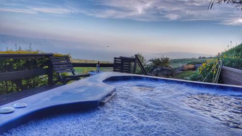a hot tub in a backyard with a view of the ocean at Sea Of Galilee Site in Chorazim