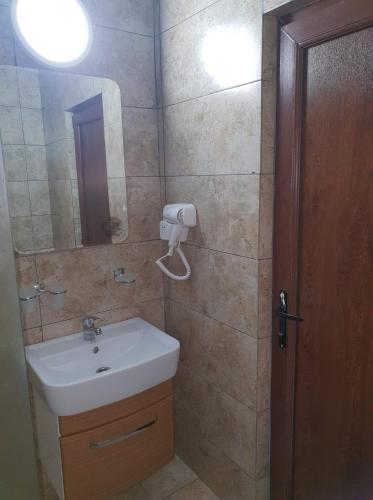 a bathroom with a sink and a mirror at ingrid in Mangalia