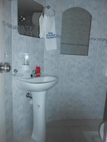 a bathroom with a white sink and a towel at HOTEL 25 DE MAYO in Fray Bentos