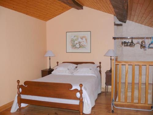 a bedroom with a bed with white sheets and pillows at Les Oiseaux in Saint-Émilion