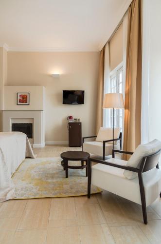 a living room with a couch and a chair at Hotel Spiess & Spiess in Vienna