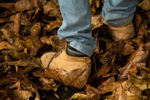 a person with their foot in a shoe in the leaves at Eco Hotel El Columpio in Salento