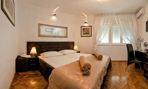 a bedroom with a bed and a desk and a window at Luxury APP OLD TOWN PALACE in Split