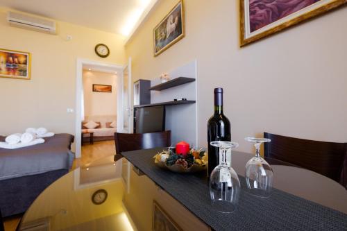 a room with a bottle of wine on a counter at Jolie in Belgrade