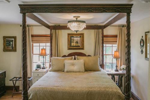 a bedroom with a large bed with a canopy at Airwell Bed and Breakfast in Purcellville