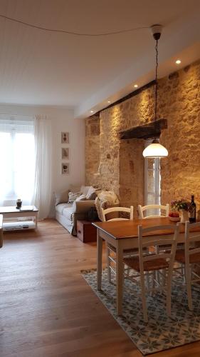 a living room with a table and a couch at Le Rousseau Sarlat in Sarlat-la-Canéda