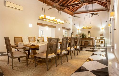 
a dining room with chairs, tables, and tables in it at Hotel Casa Don Sancho By Mustique in Cartagena de Indias
