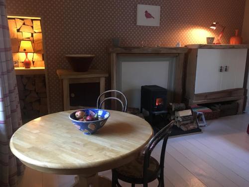 
a living room with a table and a fire place at Ardmore House B&B in Lochinver
