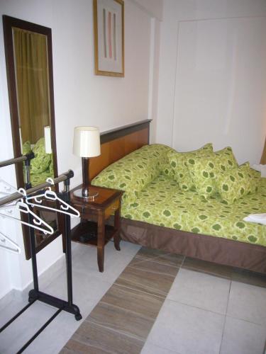 a bedroom with a bed and a table and a mirror at Villa Mar Bella in Costinesti