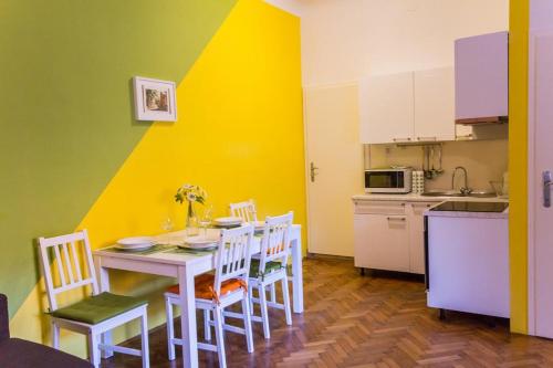 a kitchen with a table and chairs in a room at Apartment Bright & Light in Ljubljana