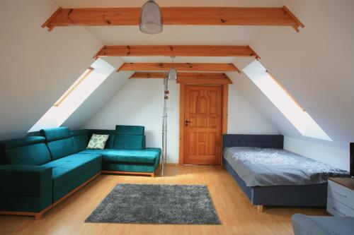a living room with a couch and a bed at Uroczysko Teremiski in Białowieża
