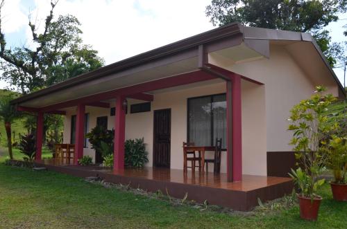 a small house with a patio at Lumbres Arenal in Fortuna