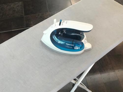 a blue and white iron sitting on a table at K's Street Hotel Miyazaki in Miyazaki