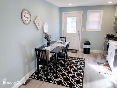 a dining room with a table with chairs and a rug at Nice bedroom next fells point in Baltimore