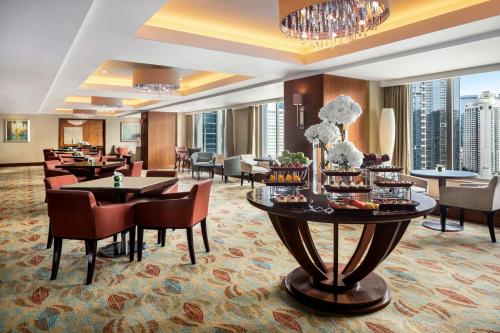 a hotel lobby with a table with food on it at Shangri-La Jakarta in Jakarta