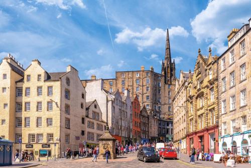 a city street with many buildings and a church at Grassmarket Old Town Boutique Apartment in Edinburgh