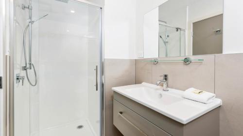 a bathroom with a sink and a shower at Remarkables Garden Apartment 305 in Queenstown