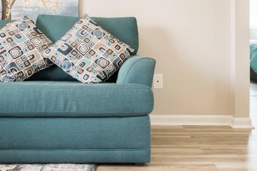 a blue couch in a living room with pillows on it at Cute Condo in Rock Hill-45 in Rock Hill