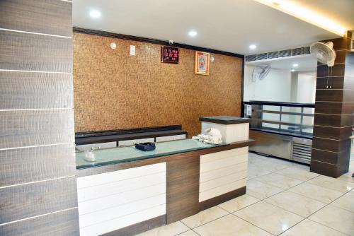 a kitchen with a counter in a room at Hotel Midtown & Restaurant in Jhunjhunūn