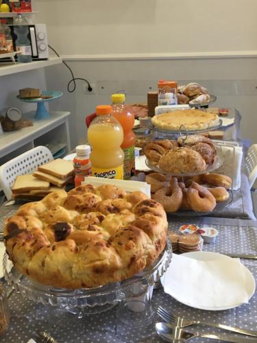 a table with a pie and other pastries on it at Maison De luxe in Pompei