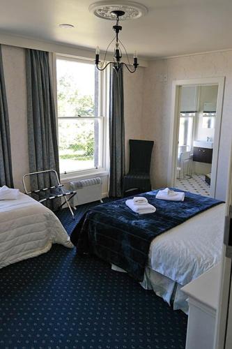 a hotel room with a bed and a window at Royal Mail Hotel in Lumsden