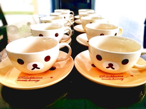 a row of coffee cups on plates on a table at SLV Small Luxury Villa - Villa B in Malacca
