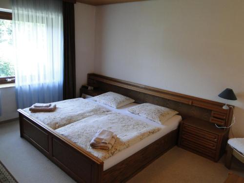 a bedroom with a bed with two towels on it at Ferienhaus Luhetalblick Prescher in Bispingen