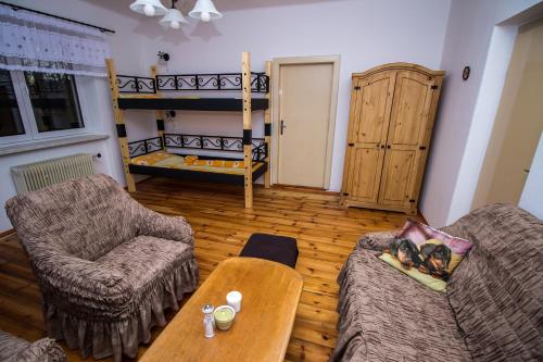 a living room with a couch and a bunk bed at Rozboudovec in Křemže