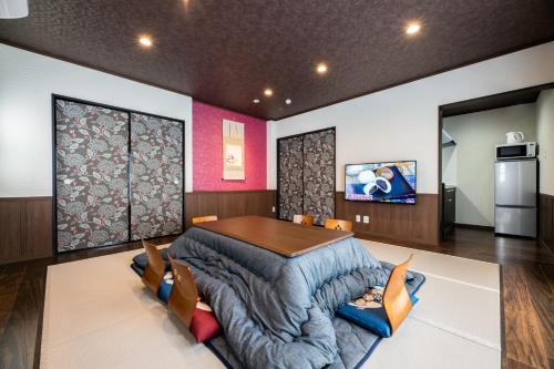 a dining room with a table and a couch at Kotonone Mai Suzu in Yufuin