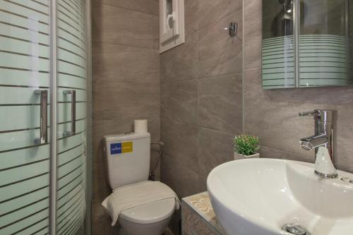 ein Badezimmer mit einem weißen WC und einem Waschbecken in der Unterkunft Deluxe Arch of Galerius in Thessaloniki